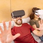 Photo of two people wearing VR headsets looking like they are playing a game and enjoying it - Exploring the Future of Online Slots with Virtual and Augmented Reality