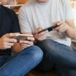 Young men playing casino games on their mobile devices