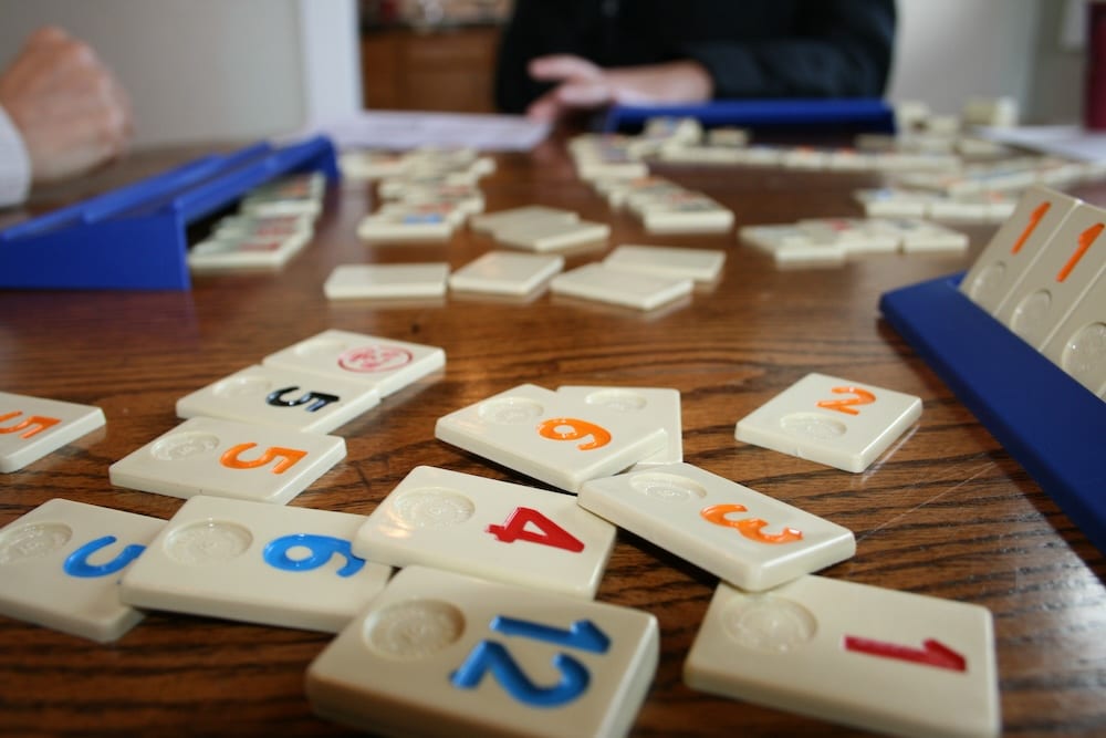 Photo of rummy tiles people happy playing a game of rummy