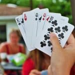 Over the shoulder view of a young woman playing Euchre