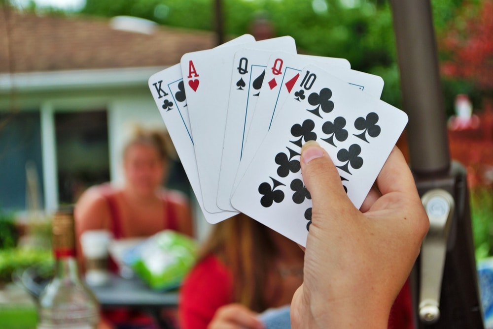 Over the shoulder view of a young woman playing Euchre