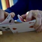 A closeup of hands shuffling a deck of cards